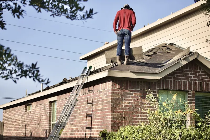 Professional roofer working on a residential roof in Helena Valley West Central